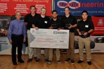 Team 16039 University students with presenter giving them a large award check